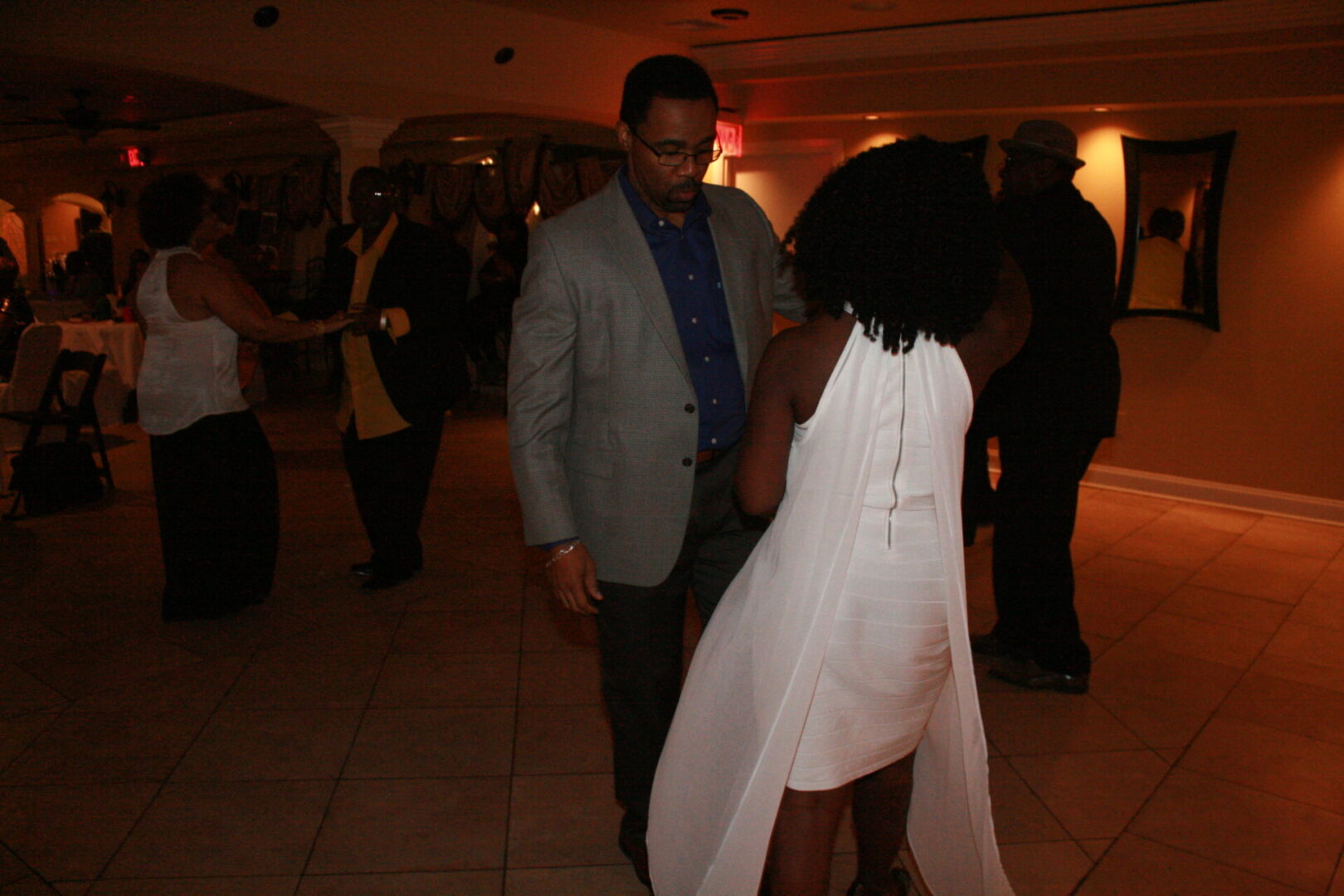 A man and woman dancing at an event.
